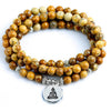 Coiled 108 bead agate mala bracelet with a silver-tone Buddha pendant on a white background