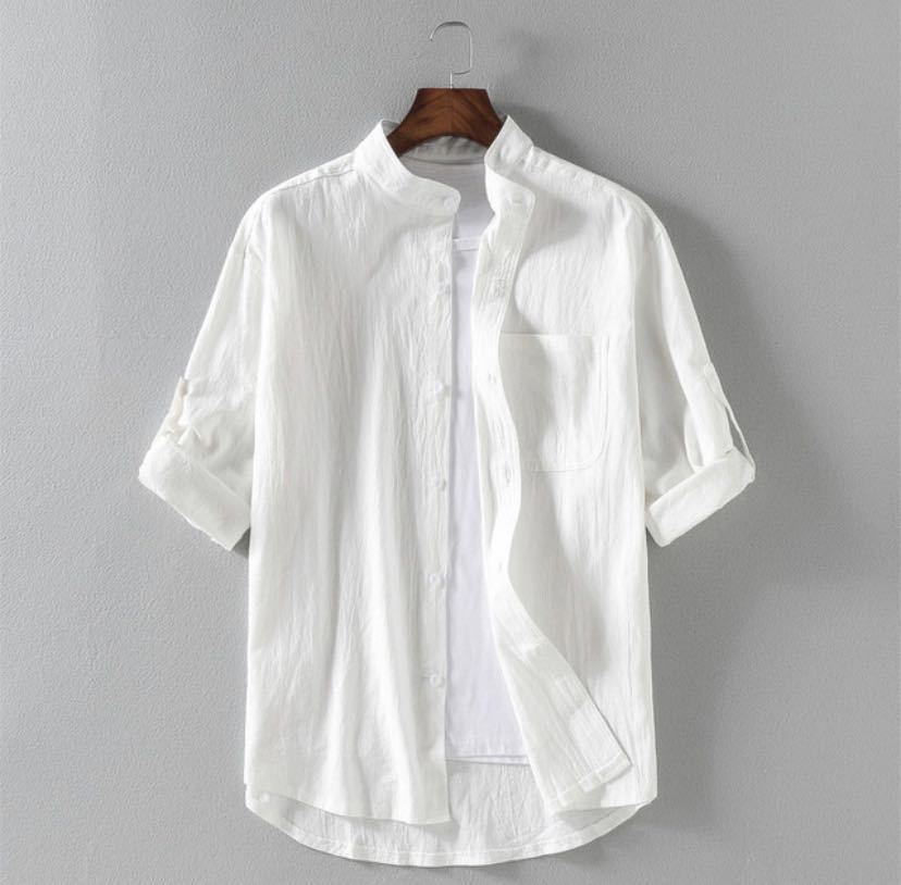 White linen blend men's shirt with stand collar hanging on a wooden hanger