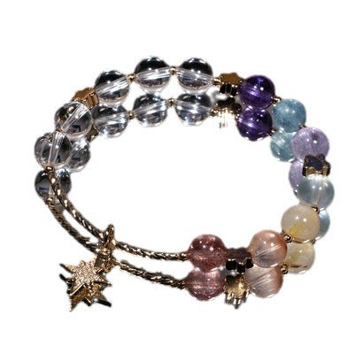 Multi-colored crystal bead bracelet with a gold star charm on a white background