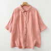 Pink and light purple women's half sleeve shirts laid flat on a white background
