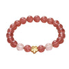 Pink strawberry quartz beaded bracelet with a gold flower charm