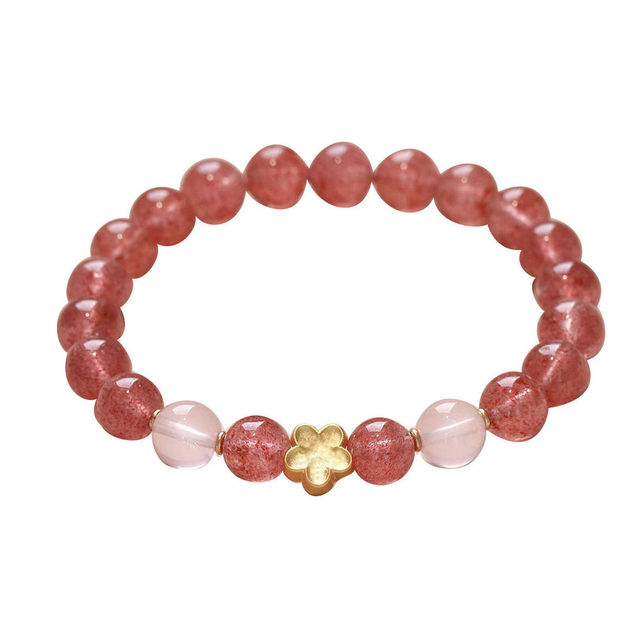 Pink strawberry quartz beaded bracelet with a gold flower charm