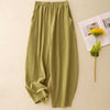 Green cotton linen wide leg pants with elastic waist laid flat