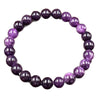 Close-up of a purple natural stone bead bracelet on a dark surface
