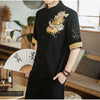 Man wearing a black short-sleeve shirt with gold dragon embroidery and traditional buttons