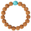 Close-up of a brown textured Bodhi seed bracelet with a yellow amber accent bead on a gray background