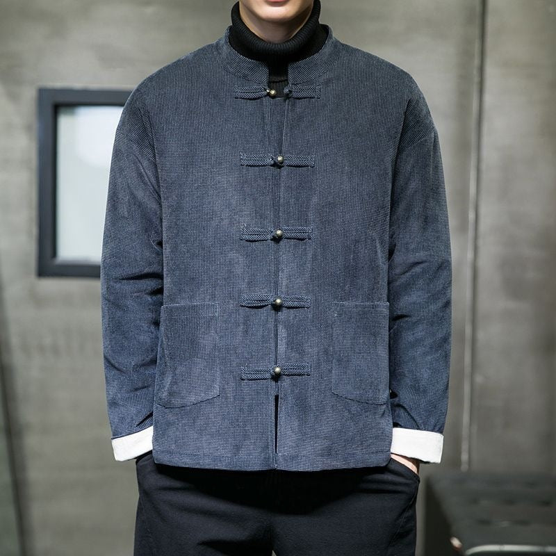 Man wearing a navy blue men's jacket with frog buttons