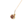 Close up of a gold plated sterling silver pomegranate pendant necklace with red stones