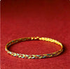 Close up of a multicolored braided string bracelet on a red background
