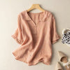 Pink linen short sleeve shirt with a middy collar hanging on a wooden hanger
