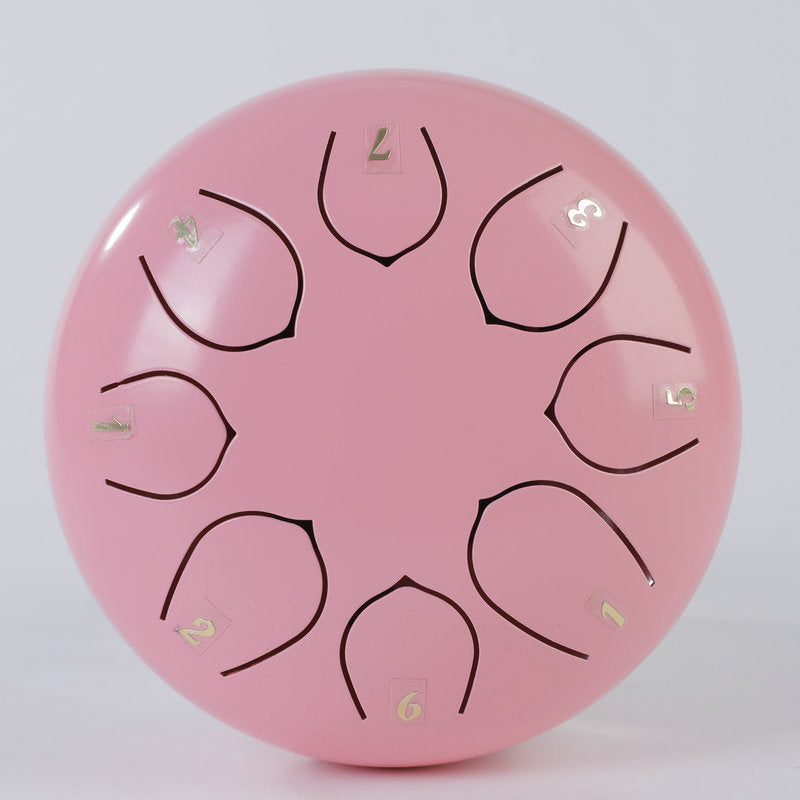 Top view of a pink 6-inch steel tongue drum with numbered tongues