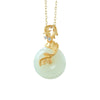 Gold-tone koi fish necklace with a white circular pendant