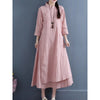 Woman wearing a pink long sleeve dress with frog buttons and a layered skirt