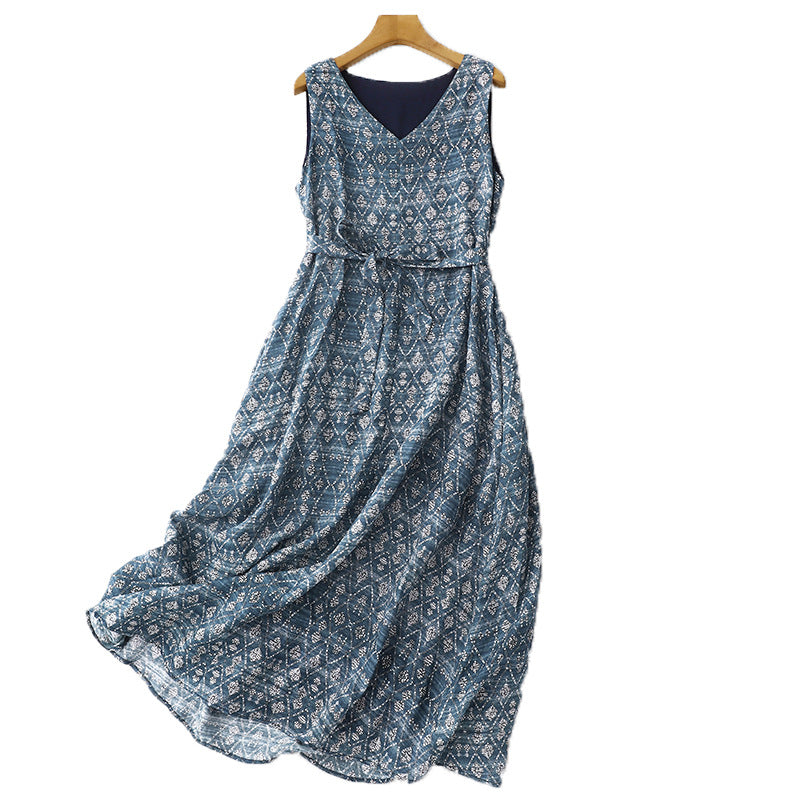 Full view of a blue sleeveless midi dress with a white geometric pattern hanging on a wooden hanger