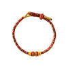 Braided red rope bracelet with gold-tone beads on white background