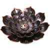 Close-up view of the dark lotus-shaped incense burner with six holes in the center.
