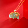 Gold plated sterling silver elephant pendant on a chain against a red background