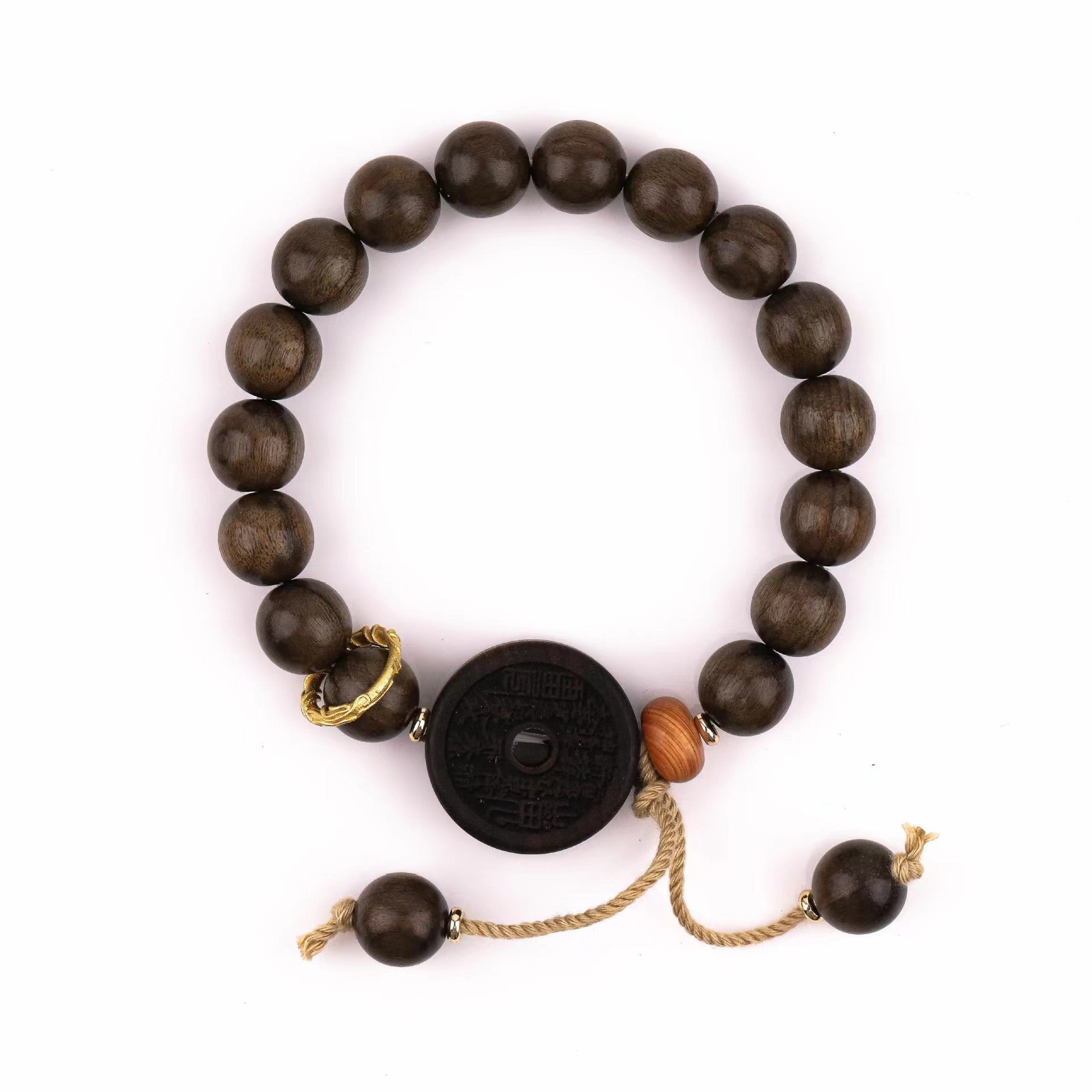 Dark wood bead bracelet with a black coin charm on a wrist
