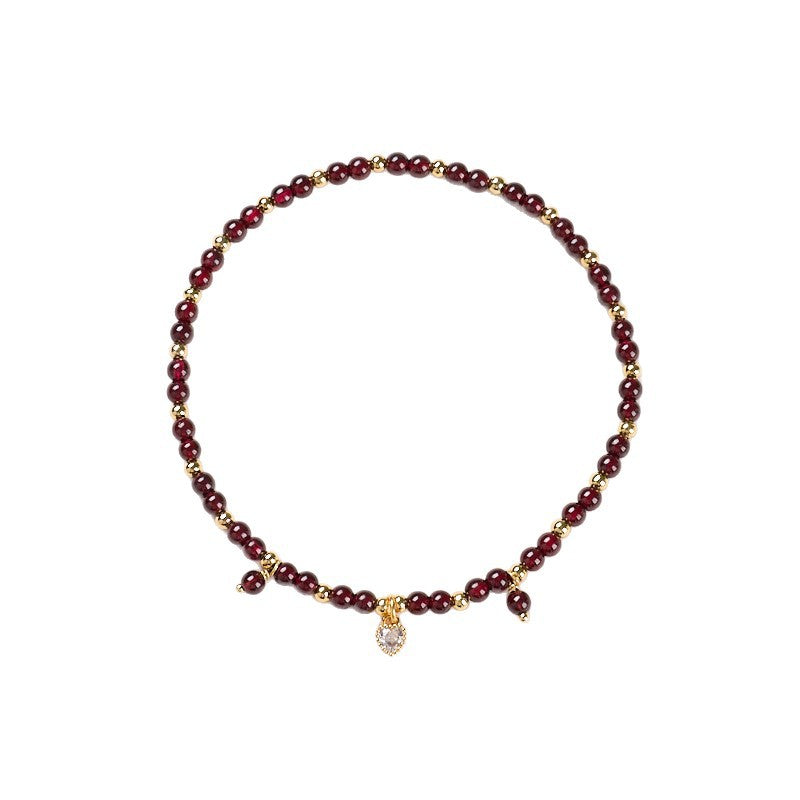 Natural garnet anklet with gold spacers and a white heart charm