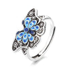 Vintage copper ring with blue enamel butterfly design on an adjustable band