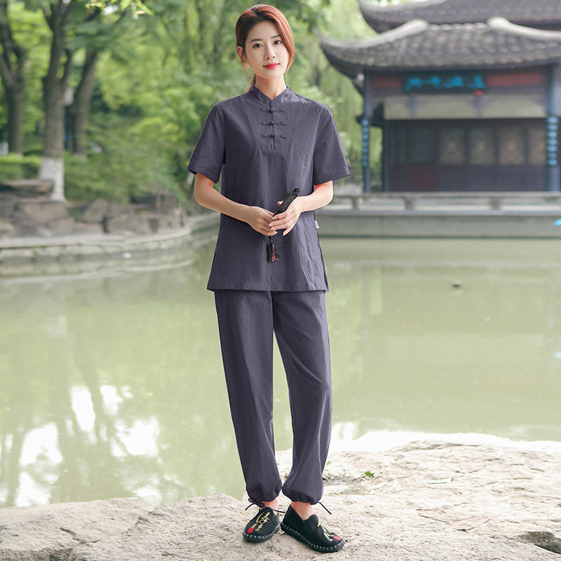 Model wearing a dark blue cotton linen meditation set by a pond