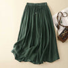 Green linen midi skirt with elastic waist and drawstring laid flat