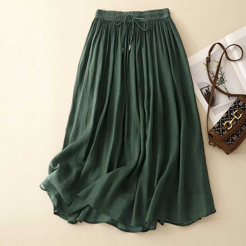 Green linen midi skirt with elastic waist and drawstring laid flat
