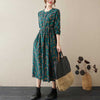 Woman wearing a green floral cotton linen midi dress with long sleeves