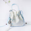 Embroidered Canvas Crossbody Bag with Tassels