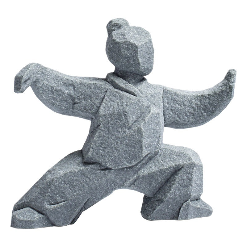 Grey stone-textured figurine of a person in a Tai Chi martial arts pose