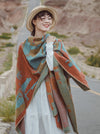 Woman wearing an orange and blue geometric Tibetan shawl outdoors
