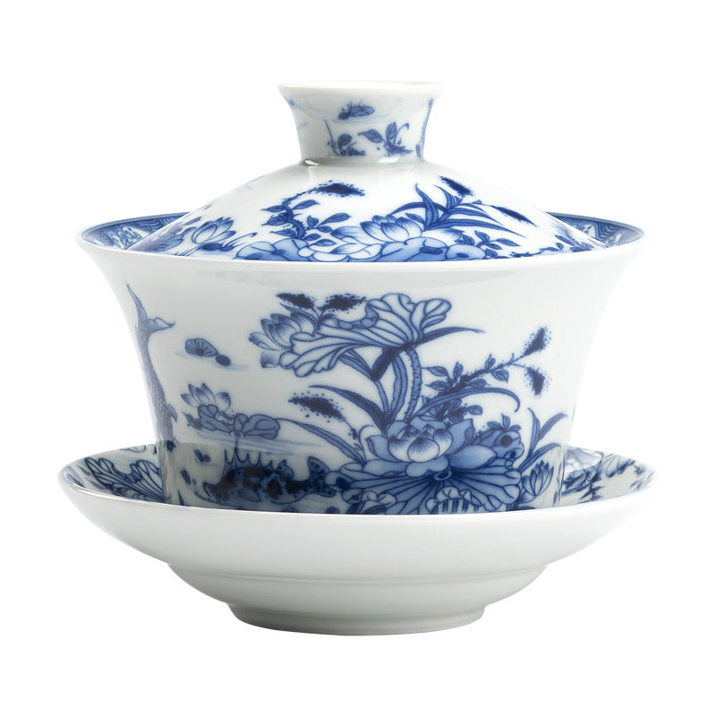 Blue and white porcelain gaiwan teacup with lid and saucer featuring a lotus flower pattern