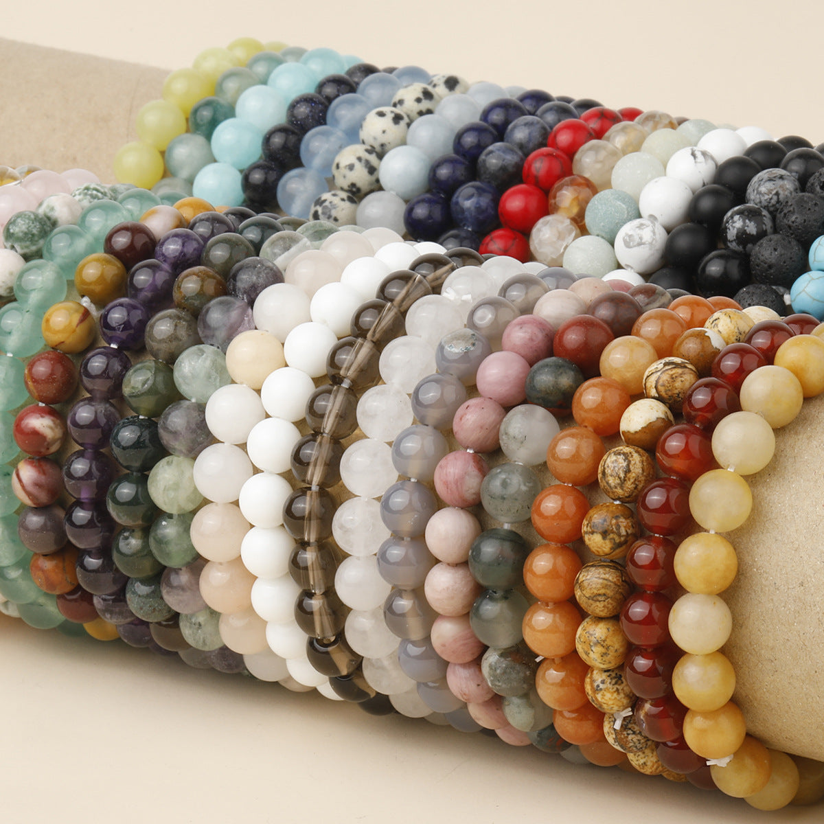 Collection of colorful natural stone bracelets on a display arm