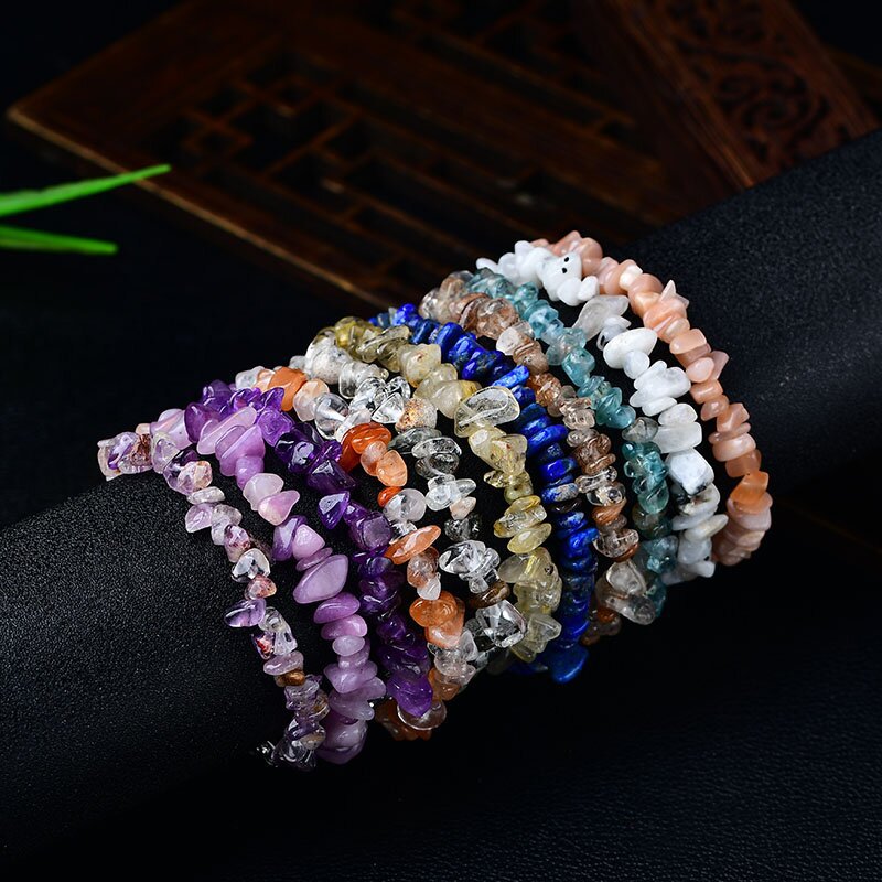 A stack of colorful natural stone chip bracelets on a wrist