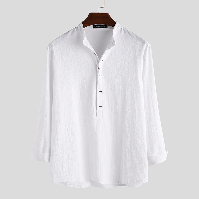 White long sleeve cotton shirt with a stand collar and half button placket on a hanger