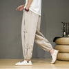 Man wearing beige vintage harem pants with side frog buttons
