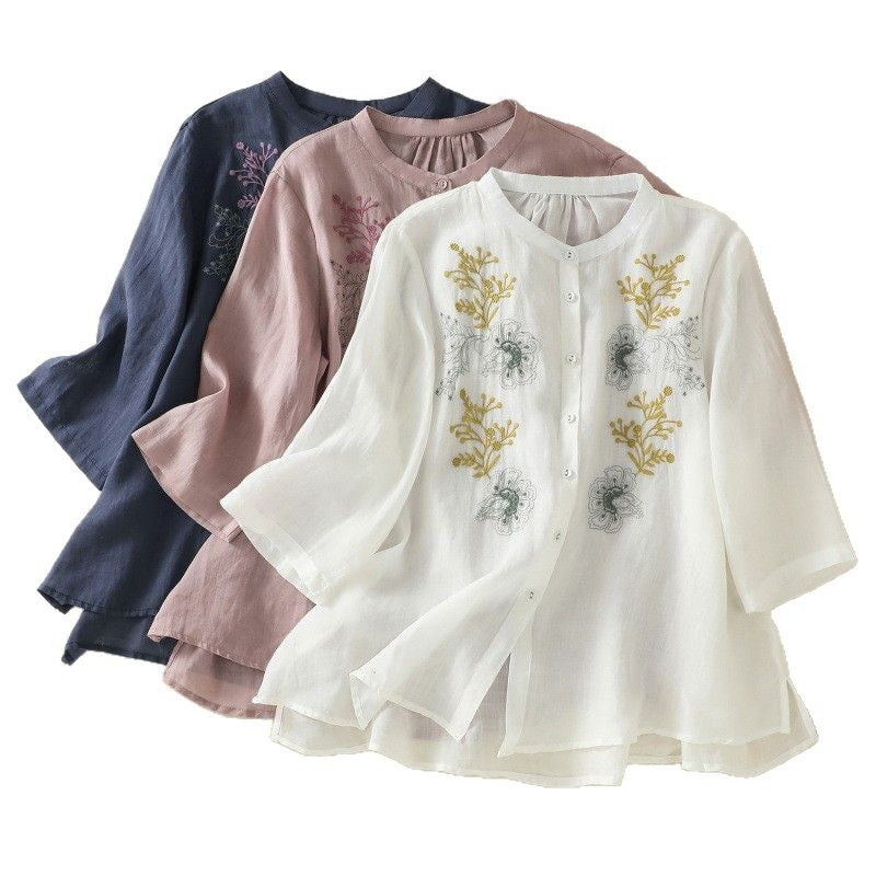 Three women's shirts in white, pink, and blue with floral embroidery and stand collars