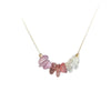 Gold tone necklace with pink and clear crystal chips on a white background