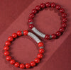 Red cinnabar bead bracelet with a silver cylinder charm engraved with mantras