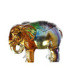 A close-up of a multi-colored handmade glass elephant figurine against a white background.