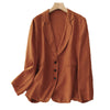 A rust-colored women's linen blend blazer jacket hanging on a wooden hanger