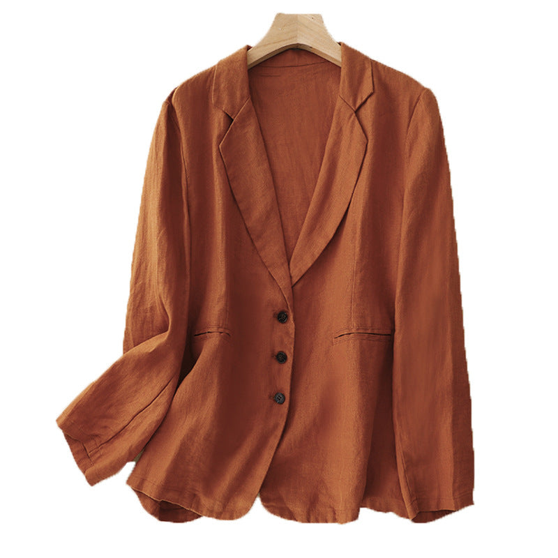 A rust-colored women's linen blend blazer jacket hanging on a wooden hanger