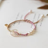 Pink braided bracelet with a white chalcedony peace buckle charm
