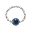 Close up of a blue agate bead ring on a finger