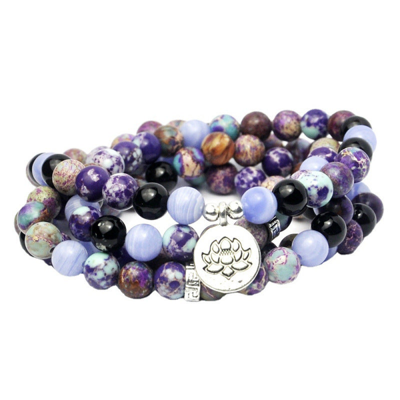 Coiled multi-strand beaded bracelet with purple spotted stones and a silver lotus charm