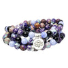 Coiled multi-strand beaded bracelet with purple spotted stones and a silver lotus charm