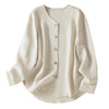 Cream colored long sleeve linen shirt with v-neck and buttons