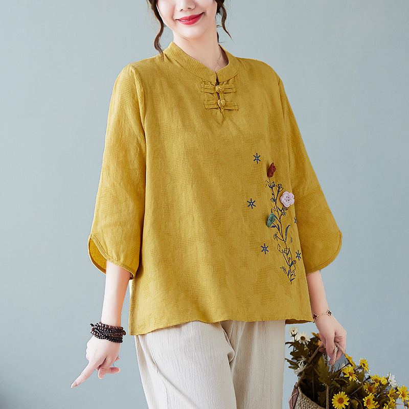 Model wearing a light green embroidered cotton-linen top with beige pants