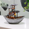 Tabletop fountain with tiered lotus leaves and glowing LED light in a silver finish