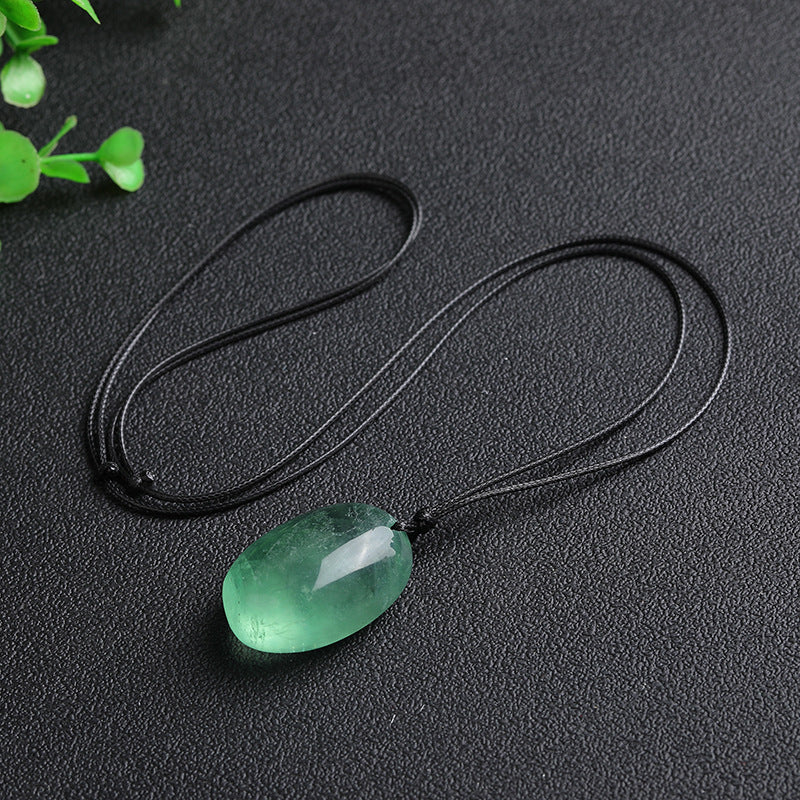 Polished green fluorite stone pendant on a black cord